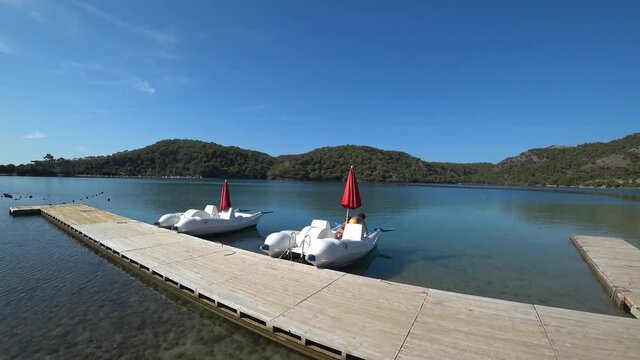 Oludeniz beach, Fethiye, Turkey - 24th of October 2020: 4K Boys play on the water cycles in the Blue lagoon

