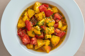 Colorful summer salad with tomato and peach, close up. Top view.