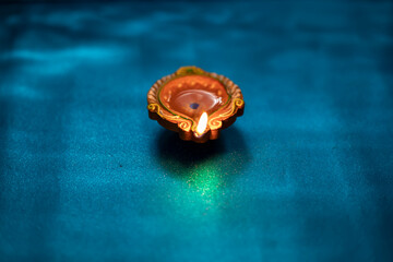 Colorful clay diya lamps lit during diwali celebration, selective focus