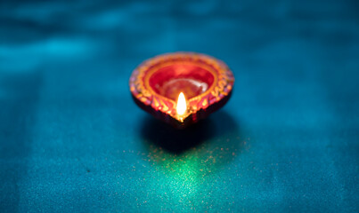 Colorful clay diya lamps lit during diwali celebration, selective focus