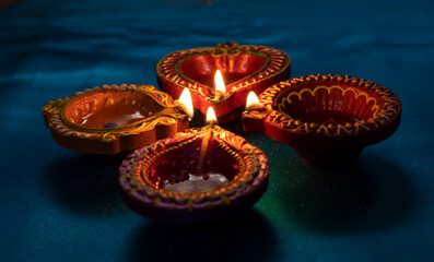 Happy Diwali - Colorful clay diya lamps lit during diwali celebration