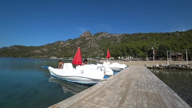 Oludeniz beach, Fethiye, Turkey - 24th of October 2020: 4K Kids play on a hydrocycle at the Blue lagoon beach
