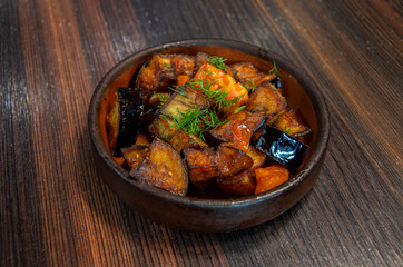 Hot spicy eggplant with tomatoes. Eggplant saute. Grilled eggplants.Vegan food.
