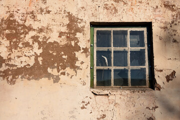 old broken window to barn in stone and concrete