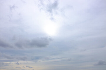 Naklejka na ściany i meble White sky with clouds and sun on sunny background.