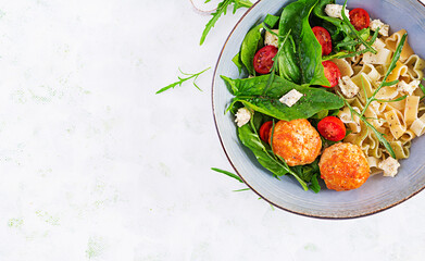 Italian pasta. Pasta  with meatballs,  cheese and fresh salad on light background. Dinner. Top view, overhead. Slow food concept