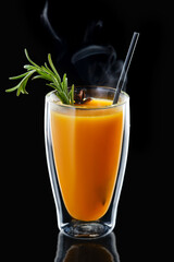 Double wall glass with hot orange and anise drink