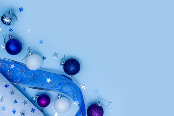 Blue Christmas or New Year holiday background. Blue, violet and white Christmas balls around xmas...