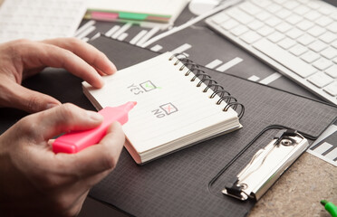 Male hand holds a marker. Yes and No