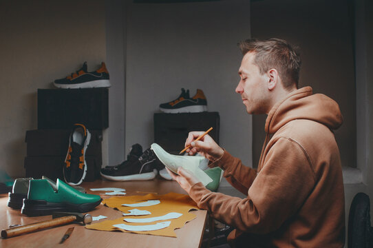 Shoemaker drawing a pattern on the shoe model