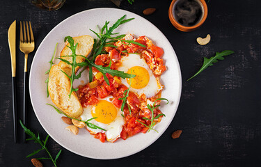 Late breakfast - fried eggs with vegetables. Shakshuka. Arabic cuisine. Kosher food. Top view