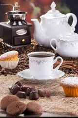 gourmet delicious black coffee with chocolates and cookies