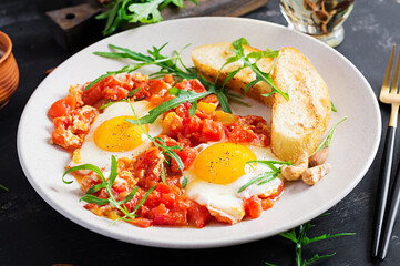 Late breakfast - fried eggs with vegetables. Shakshuka. Arabic cuisine. Kosher food.