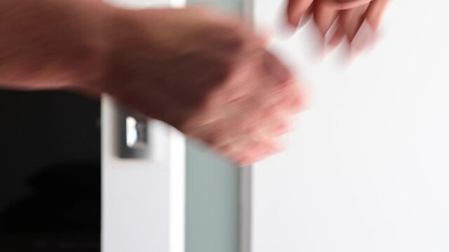 Two People Shaking Hands And Passing House Keys