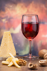 wonderful red grape wine and delicious cheese with walnuts on the table
