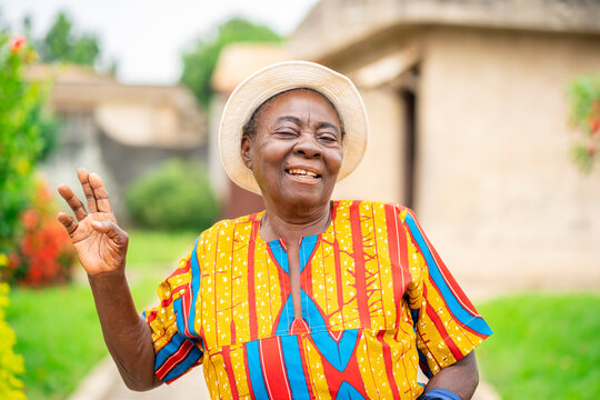 image of cheerful african aged woman, with a raised arm