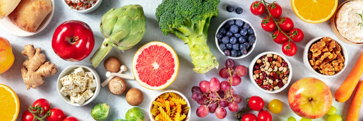 Vegetarian food panorama. Healthy organic fruit and vegetables, shot from above with legumes,...