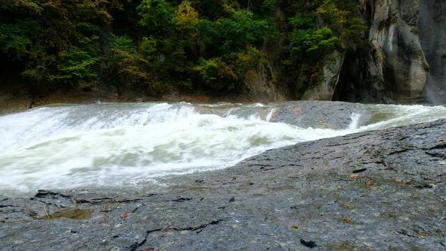 A large water stream that flows noisily in a huge rocky environment, 4K resolution, Fukiware Falls is often called "Japan's version of Niagara Falls", next to Numata, near Nikko National Park, Japan.