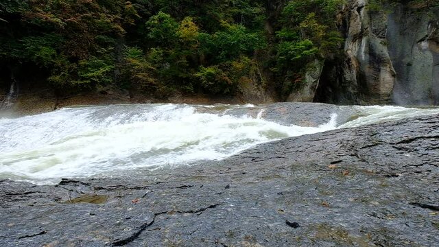 A slow motion of a large water stream that flows noisily in a huge rocky environment, Fukiware Falls is often called "Japan's version of Niagara Falls", next to Numata, near Nikko National Park, Japan