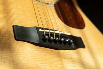 Fototapeta premium close-up shot of acoustic guitar saddle and strings