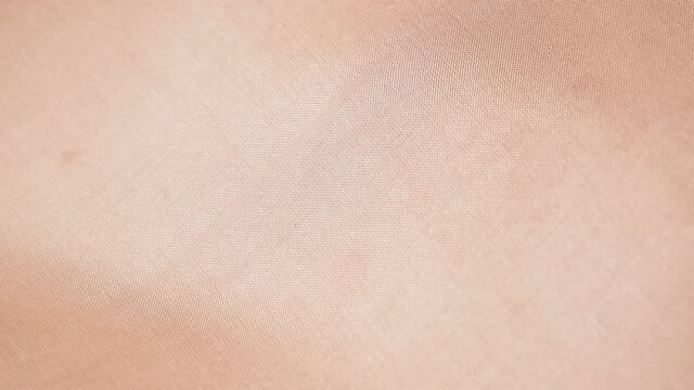 Light pink fabric texture, silk background, surface, closeup