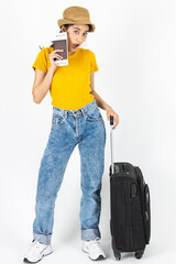 Attractive young Asian woman traveler holding passport and luggage over white isolated background. Ready for summer vacation