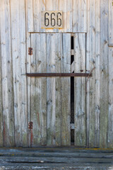 Ancient Abandoned Barn Door with number 666