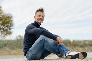 Casual fit man relaxing at the seaside