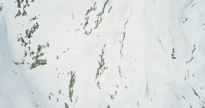 Aerial view of snowy mountain ridge.Snowcapped mountains. Snowy mountains. Cloud shadow in the snow