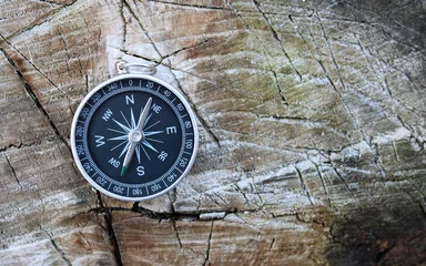 Fotobehang round compass on natural wooden background as symbol of tourism with compass, travel with compass and outdoor activities with compass © yarbeer