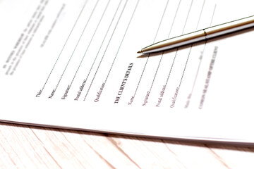 Sign the name on a paper with a pen