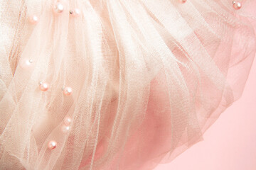 Beautiful nude pink tulle with shiny beads background. Draped background of pink powdery fabric,...
