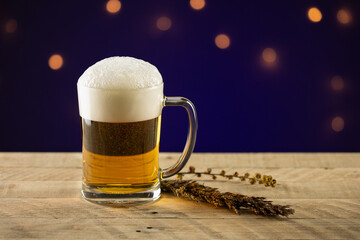 Lager on a wooden table with blue background