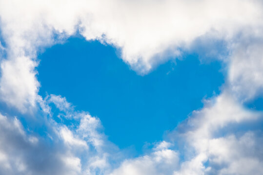 Real blue heart from cloud in the blue sky. Valentine's Day. Symbol of love