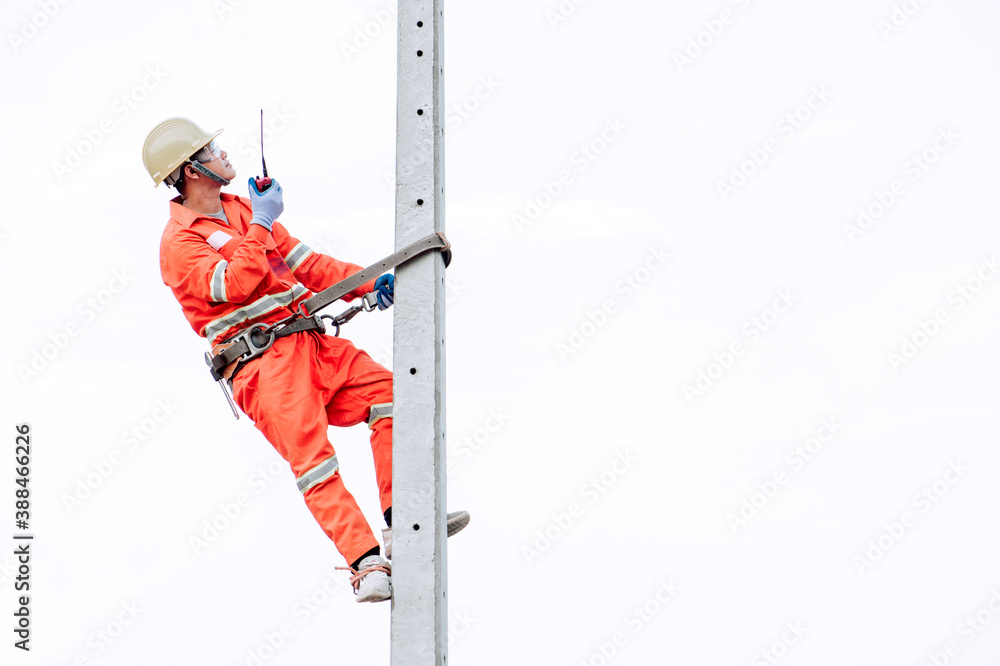 Poster an electrician in a safety suit is climbing a light pole to go up and check availability of the elec