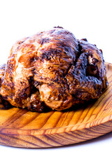 Roast chicken on a wooden tray on white background