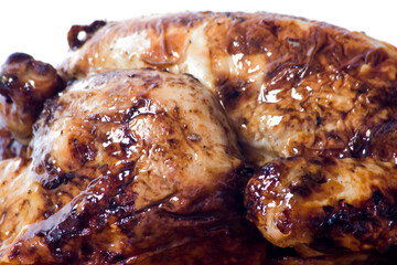 Roast chicken on a wooden tray on white background