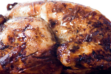 Roast chicken on a wooden tray on white background
