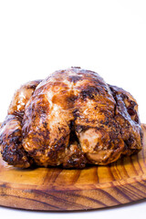 Roast chicken on a wooden tray on white background