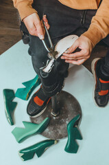 Close up of shoemaker making shoe using shoemaker tools - obrazy, fototapety, plakaty