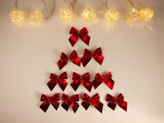 Tree made of bows and garland on white background. Christmas composition. Great background for your desires