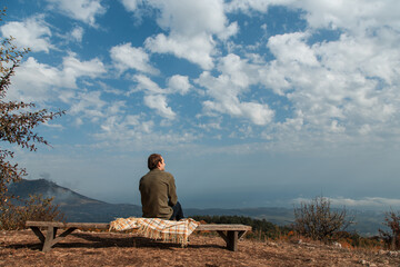 man sitting on a rock