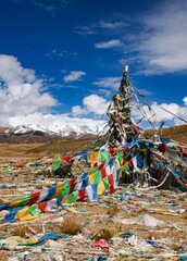 Prayer flags Stupa in Tibet snow mountains background blue sky clouds vertical 