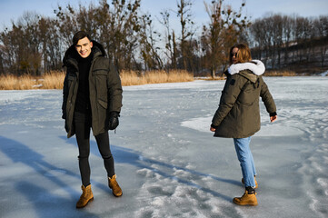 happy couple hugging and laughing outdoors in winter