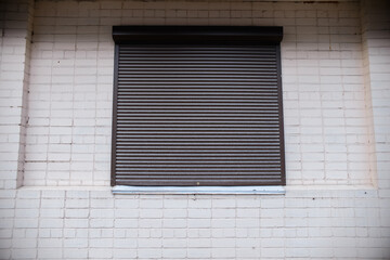 Window shutters on the building. Closed shop. Lockdown, bankruptcy, street riots concept