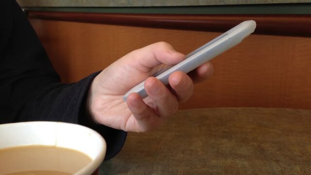 Reading moile phone message inside the coffee shop