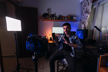 Chico joven con barba y mascarilla creando contenido audiovisual para plataformas digitales
