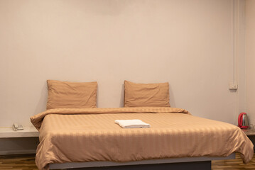 Fototapeta na wymiar Bed with orange pillows and blanket