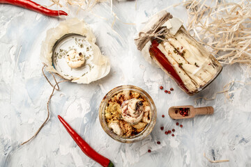 Assortment of cheese. Soft, hard, cheese balls. Ecology and eco-products, Jar with cheese marinated in oil, top view