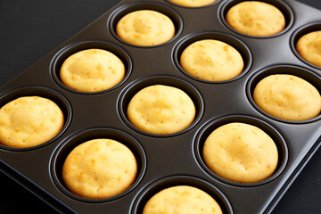 Homemade Cornbread Muffins on a black background, side view. Close-up.